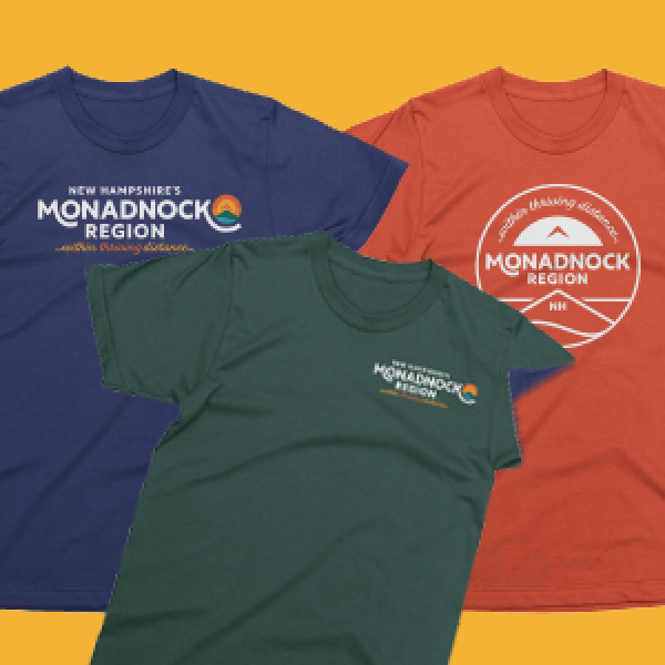 Colorful t-shirts with the Greater Monadnock logo on them