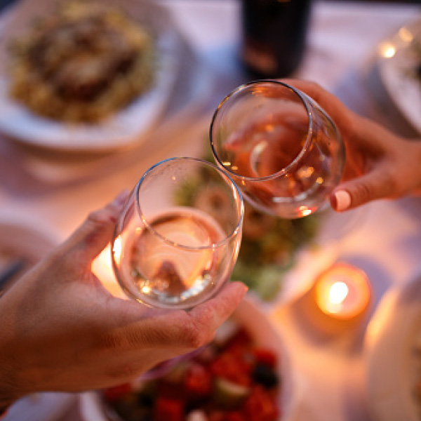 clicking wine glasses at restaurant