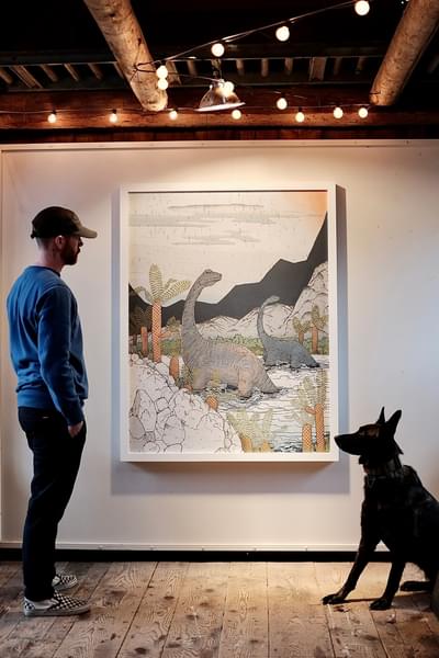 Artist Chris Myott in front of his painting with this dog